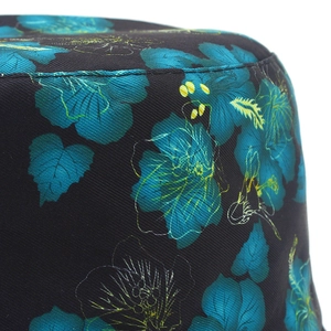 Detail shot of a double-sided sun hat with blue-green floral print and fine stitching