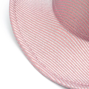 Close-up of pink and silver woven striped texture with metallic finish on party hat