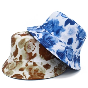 Floral print bucket hats in blue and tan patterns for stylish outdoor sun protection