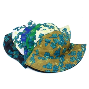Detailed top view of reversible floral bucket hats in blue, white, and khaki patterns