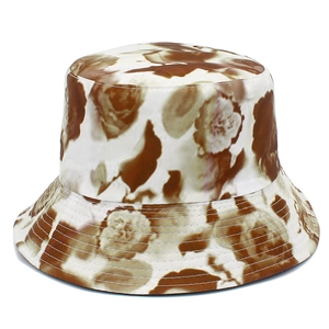 Detail of floral bucket hat showing dense stitching on the brim and abstract print pattern