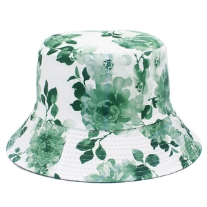 Close-up of green floral print on white cotton sun hat with reinforced stitched brim