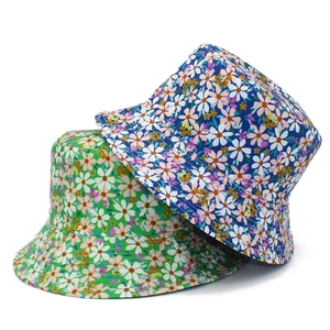 Floral reversible bucket hats for women in green and blue with daisy patterns