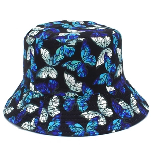 Detailed close-up of a black bucket hat with vibrant blue and white butterfly pattern print