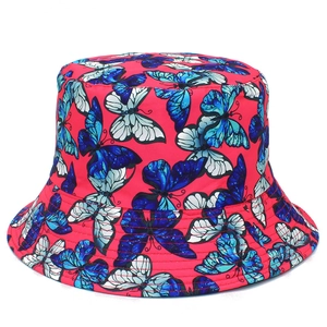 Detail of red bucket hat featuring blue butterfly prints and reinforced stitched brim