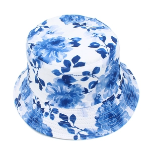 Detailed top view of blue ink floral print on a breathable white sun bucket hat with stitching