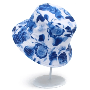 Detail of blue and white tie-dye floral pattern on a cotton sun bucket hat