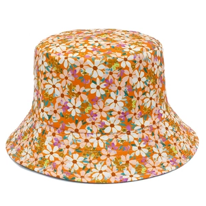 Close-up detail of the orange sun hat with white daisy floral pattern and cotton fabric
