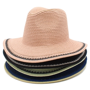 Detail of stacked summer straw hats in pink, black, cream, and navy with lace edge