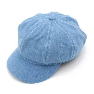 Top view of a light blue denim newsboy cap featuring eight-panel stitching and white seams