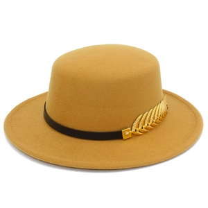 Detail of yellow wool boater hat featuring a black leather band and gold feather buckle