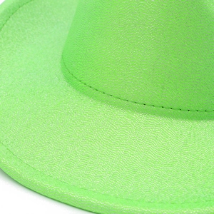 Macro shot of neon green western cowboy hat with reflective glitter texture and stitching