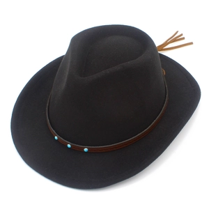 Detail of black kids cowboy hat featuring brown leather band with turquoise studs