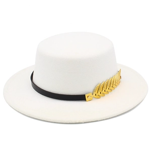 Detail of white wool felt boater hat featuring black band and golden leaf ornament