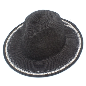 Detailed macro view of black straw sun hat with decorative white geometric lace edge trim