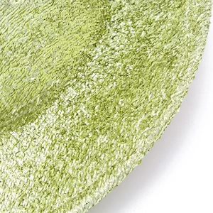 Macro shot of bright green sequin fabric showing the shiny metallic texture of the jazz hat