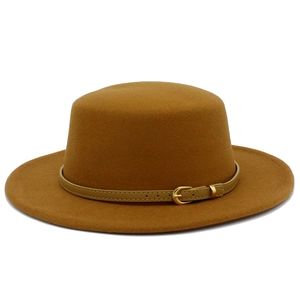 Close-up of wool felt flat-top hat featuring a light brown leather strap and gold buckle
