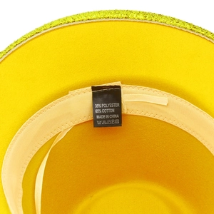 Detail of the yellow sequin jazz hat showing the 35% polyester and 65% cotton care label