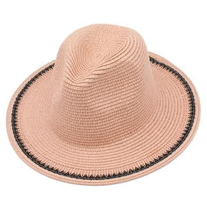 Elegant light pink straw sun hat with black decorative band for women's beach outings
