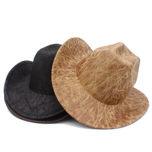 Detail of vintage faux leather cowboy hats with distressed texture in black and brown