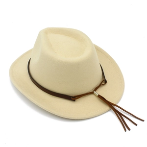 Detail of beige felt cowboy hat with brown leather band and long decorative tassels