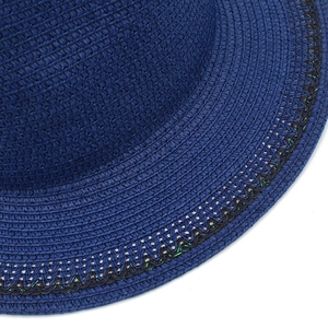 Close-up of navy blue straw hat with spiral weaving and black wavy sequin trim detail