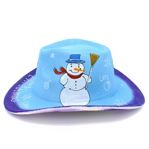 Macro shot of a light blue cowboy hat with hand-painted snowman and Merry Christmas text