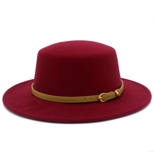Detail of burgundy wool fedora hat featuring a stylish leather belt and gold buckle