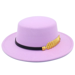 Detailed macro view of a lavender felt boater hat with a golden metallic leaf ornament