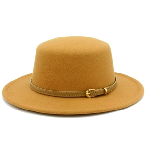 Detail of flat top wool hat in ginger yellow with a brown leather belt and golden buckle