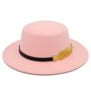Close-up of pink felt fedora with a black band and gold wheat shaped metal accent