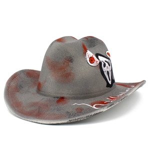 Detail of grey cowboy hat with red blood splatters and a Scream mask icon