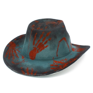 Close-up of a distressed teal cowboy hat with blood-red handprints and Happy graffiti detail