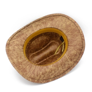 Detail of vintage brown western cowboy hat showing cracked texture and inner sweatband