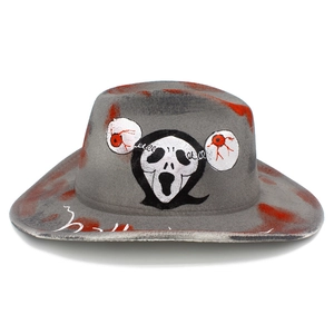 Close-up of Halloween felt cowboy hat with Ghostface mask and red blood splatter details