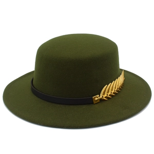 Detail of dark green flat top fedora hat with black leather band and gold feather pin