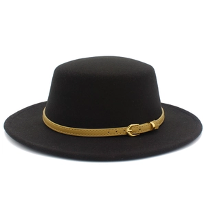 Detailed close-up of a vintage black flat top hat with khaki belt and gold buckle