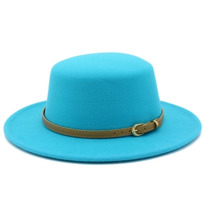 Macro shot of bright blue boater hat wool felt texture with khaki leather belt buckle