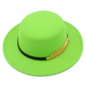 Detail of bright green flat top felt hat with black leather band and gold feather pin