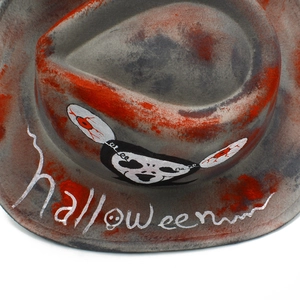 Top view of grey Halloween fedora hat with blood splatter and skull detail
