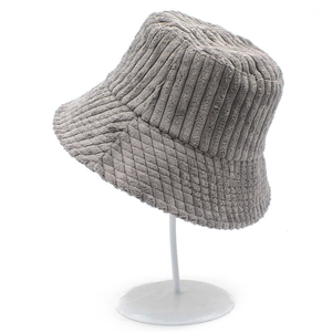 Classic grey corduroy bucket hat with quilted brim texture on a white display stand