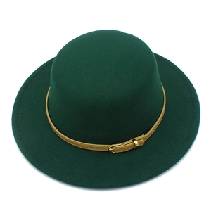 Close-up of dark green wool felt hat with light brown leather belt and gold buckle detail
