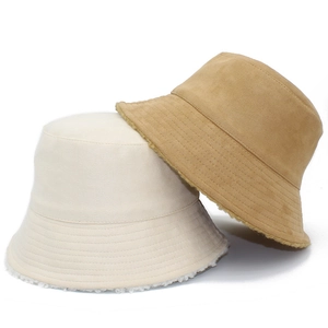 Detail of reversible lamb wool bucket hat in beige and camel colors with suede texture