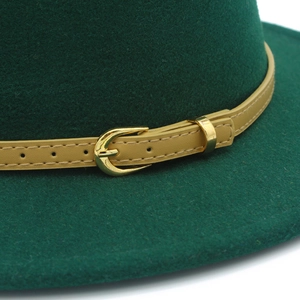 Close-up of wool felt hat showing dark green texture and camel leather belt with gold buckle