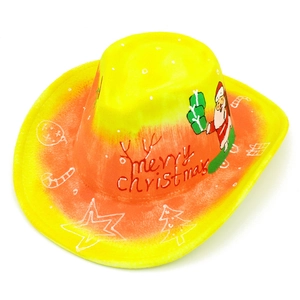 Detailed view of yellow felt cowboy hat with Merry Christmas print and festive icons