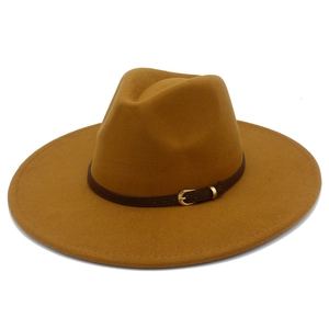 Detail of camel wool fedora hat featuring a wide brim and brown leather strap with gold buckle