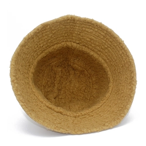 Detailed close-up of fluffy khaki lamb wool texture on reversible winter bucket hat