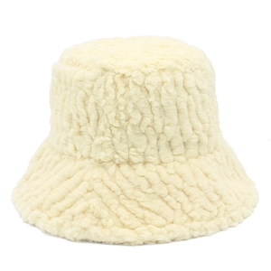 Detail showing the vertical ribbed texture of a cream faux shearling winter bucket hat