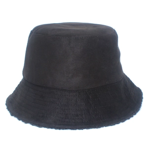Detail view of black reversible bucket hat showing parallel stitching on brim and soft texture