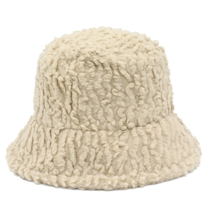 Close-up of thick beige lamb wool fabric texture on a plush winter bucket hat